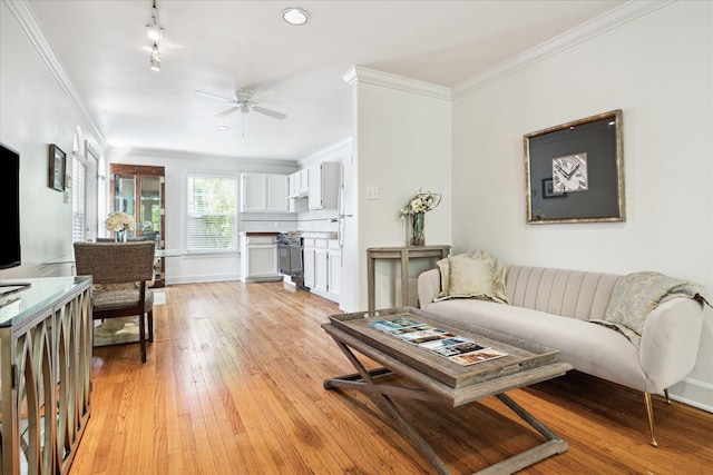 1755 Kipling St, Houston, TX 77098 - living area featuring light wood-style floors, a ceiling fan, crown molding, and baseboards