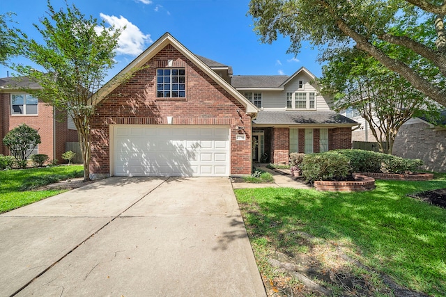 traditional-style house with a front lawn, brick siding, concrete driveway, and a shingled roof