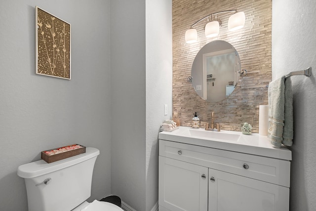 half bathroom featuring toilet and vanity