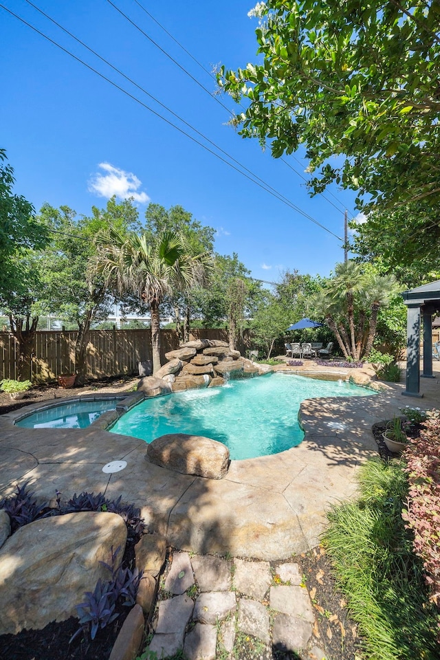 view of pool with a patio and fence