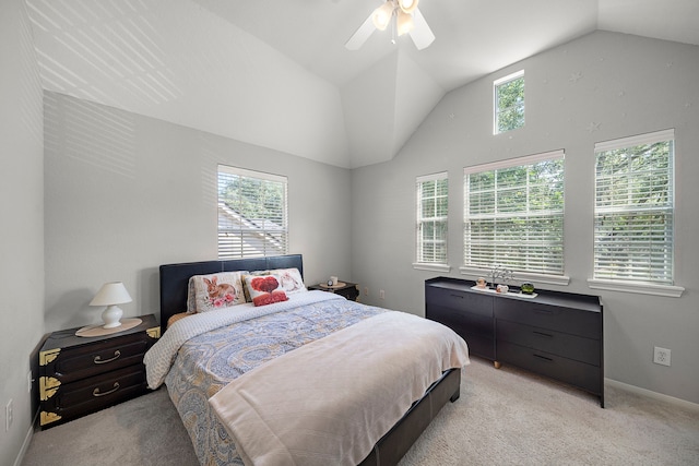 bedroom featuring lofted ceiling, light colored carpet, a ceiling fan, and baseboards