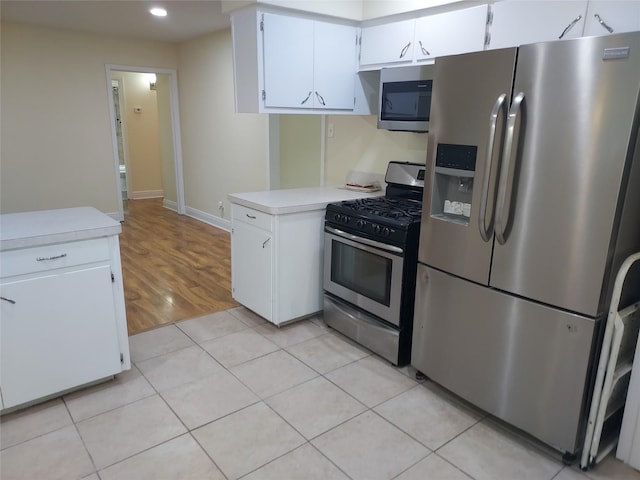 509 S Ramona St, Angleton, TX 77515 - kitchen featuring stainless steel appliances, light countertops, white cabinets, recessed lighting, and baseboards