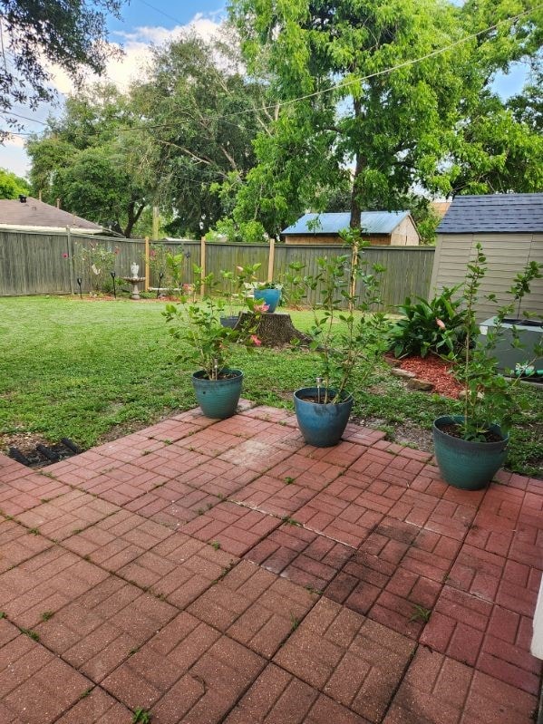 509 S Ramona St, Angleton, TX 77515 - view of patio / terrace featuring an outbuilding and a storage unit