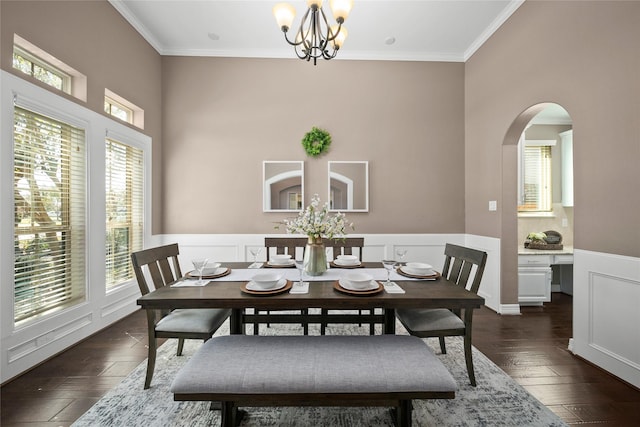 5926 Crawford Hill Ln, Sugar Land, TX 77479 - dining area featuring arched walkways, wainscoting, crown molding, dark wood-style floors, and a chandelier