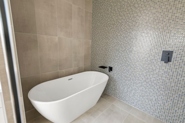 3224 Omega St, Houston, TX 77022 - bathroom featuring tile walls and a freestanding tub