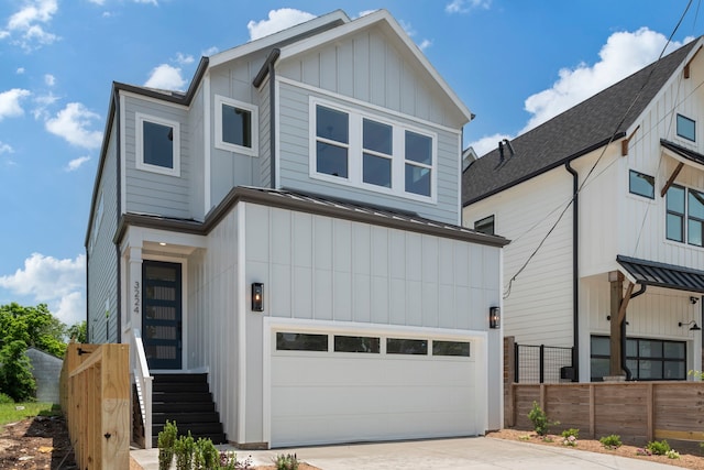 3224 Omega St, Houston, TX 77022 - view of front of home featuring a garage, board and batten siding, and driveway
