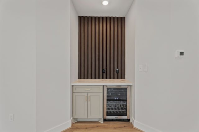 3224 Omega St, Houston, TX 77022 - indoor dry bar featuring wine cooler, light wood-style flooring, and baseboards