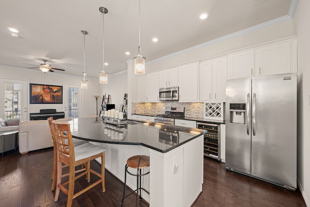 8907 Wind Springs Dr, Houston, TX 77080 - kitchen featuring stainless steel appliances, wine cooler, dark countertops, ceiling fan, and open floor plan