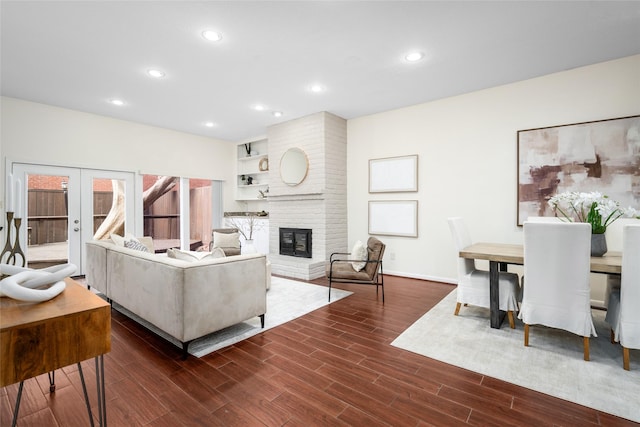 6728 Buffalo Speedway, West University Place, TX 77005 - living area with dark wood finished floors, a brick fireplace, recessed lighting, baseboards, and french doors