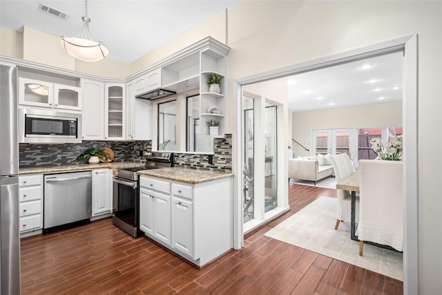 6728 Buffalo Speedway, West University Place, TX 77005 - kitchen featuring stainless steel appliances, white cabinets, backsplash, and dark wood-style flooring