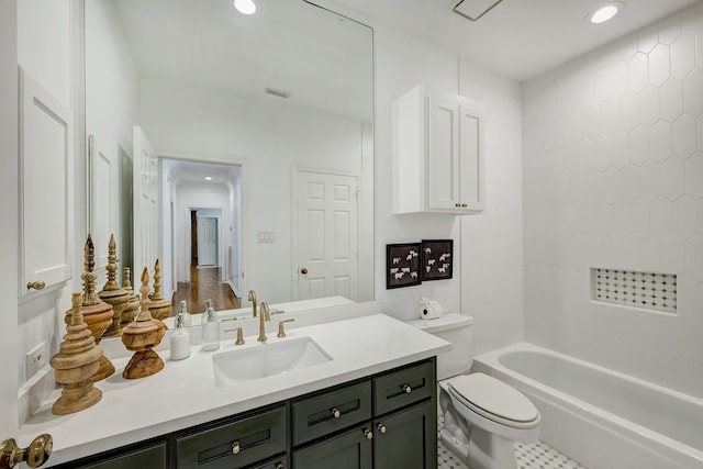 full bathroom featuring toilet, vanity, recessed lighting, and shower / washtub combination