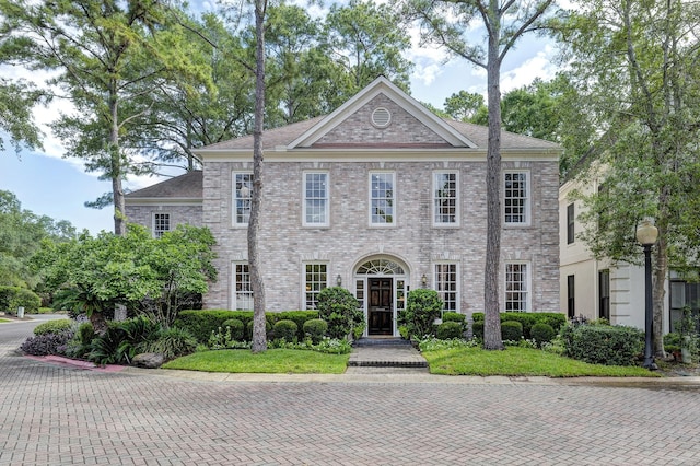 colonial home with brick siding