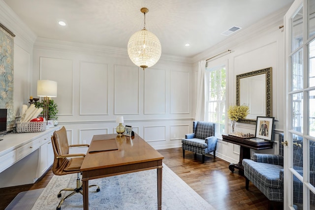 home office featuring a decorative wall, dark wood-style floors, ornamental molding, and a chandelier