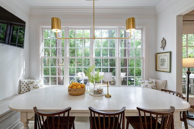 dining room featuring breakfast area and ornamental molding