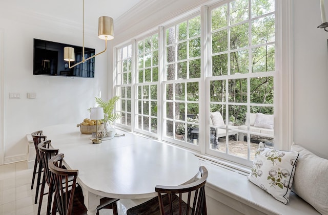 tiled dining space featuring baseboards
