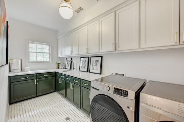 clothes washing area featuring cabinet space, washer and dryer, and light flooring