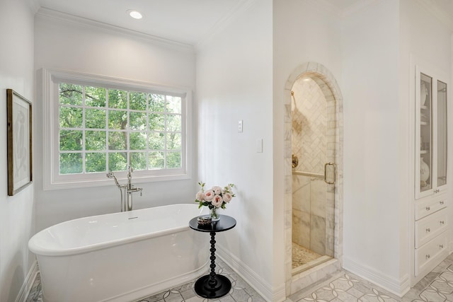 full bathroom with baseboards, a shower stall, a soaking tub, crown molding, and tile patterned floors