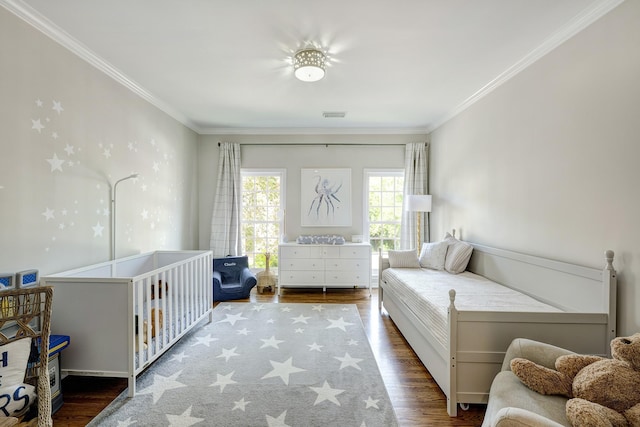 bedroom featuring crown molding and wood finished floors