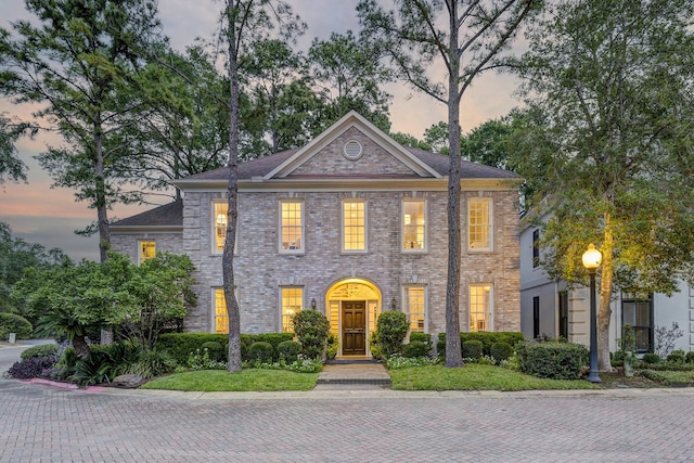 georgian-style home with brick siding