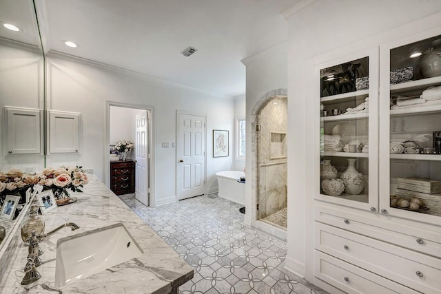 bathroom with crown molding, a freestanding bath, a shower stall, recessed lighting, and baseboards