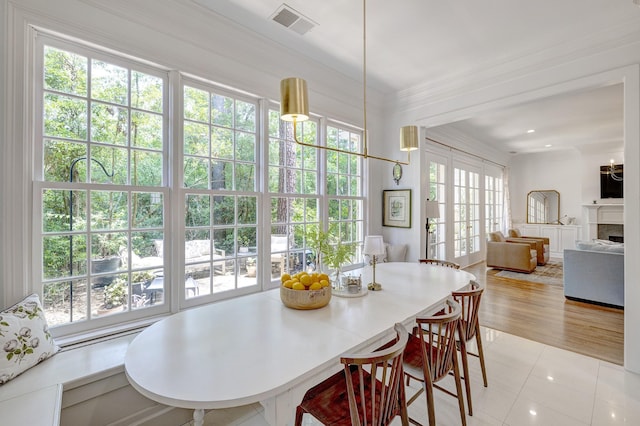 dining room with light tile patterned floors and a fireplace