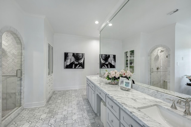 full bath with double vanity, a shower stall, crown molding, baseboards, and recessed lighting