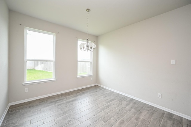 108 Shallow Creek Dr, Waller, TX 77445 - unfurnished room featuring a chandelier, wood finished floors, and baseboards