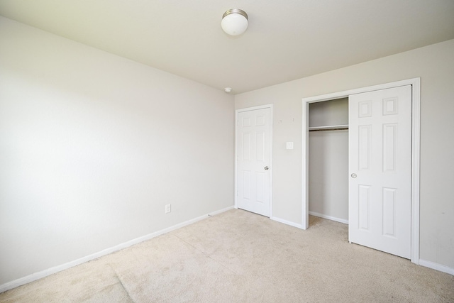 108 Shallow Creek Dr, Waller, TX 77445 - unfurnished bedroom featuring light carpet, baseboards, and a closet