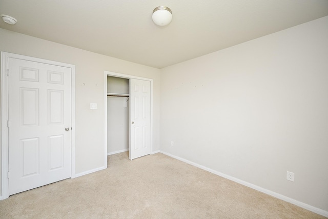 108 Shallow Creek Dr, Waller, TX 77445 - unfurnished bedroom featuring light carpet, baseboards, and a closet