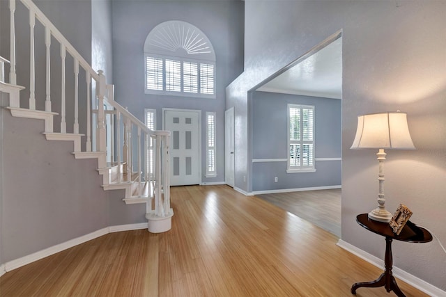 14406 Concord Grv, Houston, TX 77084 - foyer with wood finished floors, a towering ceiling, stairway, and baseboards