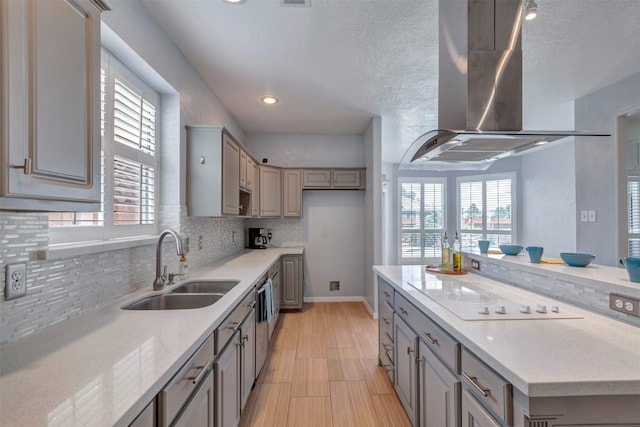 14406 Concord Grv, Houston, TX 77084 - kitchen featuring a sink, exhaust hood, gray cabinetry, white electric cooktop, and backsplash