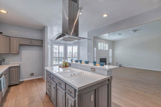 14406 Concord Grv, Houston, TX 77084 - kitchen featuring ventilation hood, white electric cooktop, gray cabinets, a center island, and recessed lighting