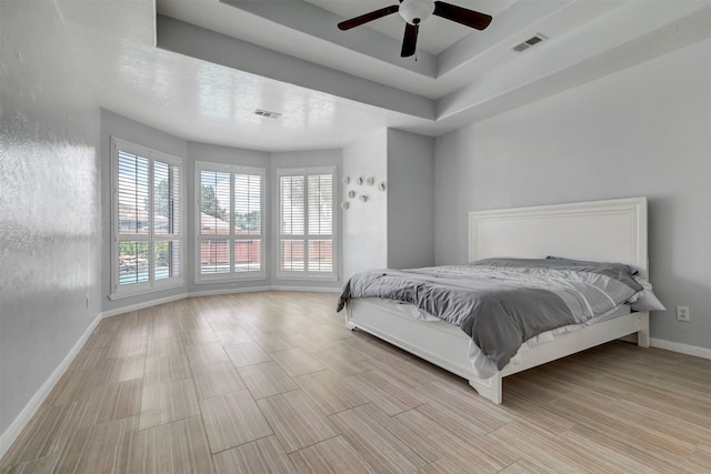 14406 Concord Grv, Houston, TX 77084 - bedroom featuring baseboards, a raised ceiling, wood finished floors, and a ceiling fan