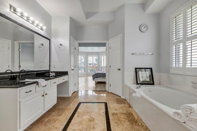 14406 Concord Grv, Houston, TX 77084 - bathroom with inlaid floor details, double vanity, a garden tub, ensuite bathroom, and marble finish floors