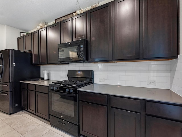 14203 Broad Cypress Ct, Houston, TX 77068 - kitchen featuring black appliances, decorative backsplash, light tile patterned flooring, dark brown cabinetry, and a textured ceiling