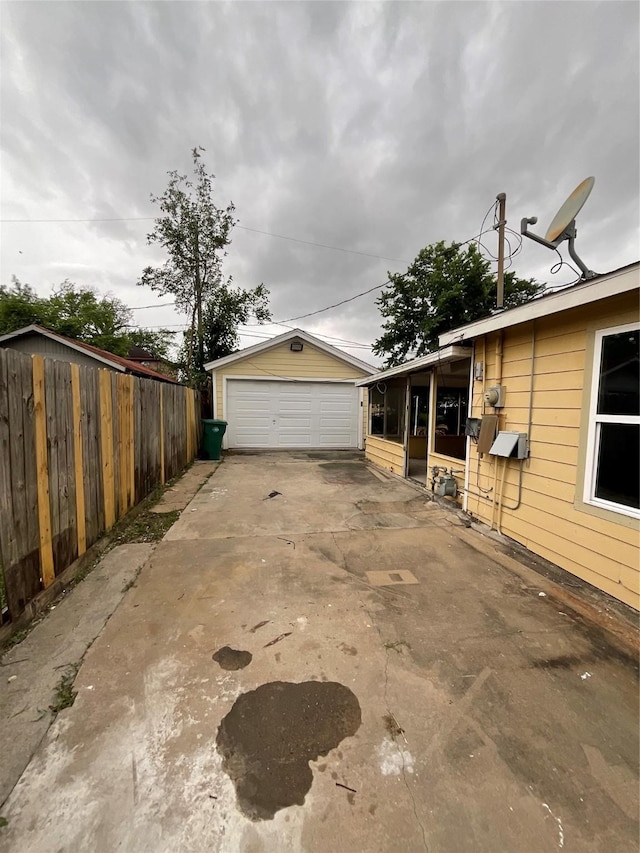 view of side of property with a garage and fence
