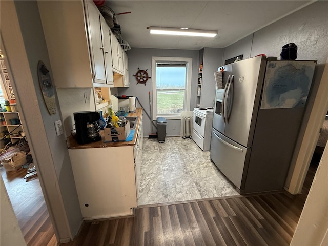 1428 Fm 2031st St S, Matagorda, TX 77414 - kitchen with stainless steel refrigerator with ice dispenser, radiator, white electric range oven, and light wood finished floors