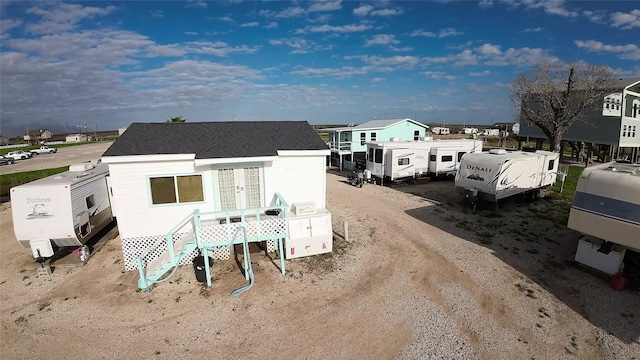 1428 Fm 2031st St S, Matagorda, TX 77414 - rear view of property featuring french doors and roof with shingles