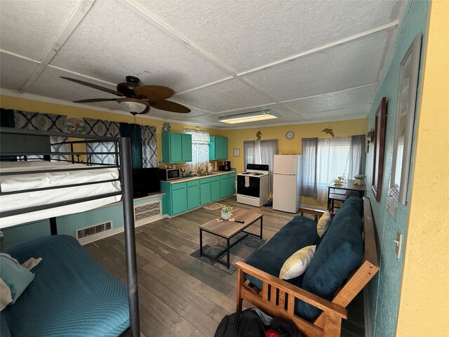 1428 Fm 2031st St S, Matagorda, TX 77414 - living room featuring hardwood / wood-style floors, ceiling fan, and healthy amount of natural light