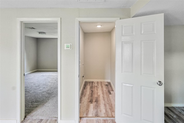 1011 N Arcola St, Angleton, TX 77515 - corridor with baseboards and wood finished floors