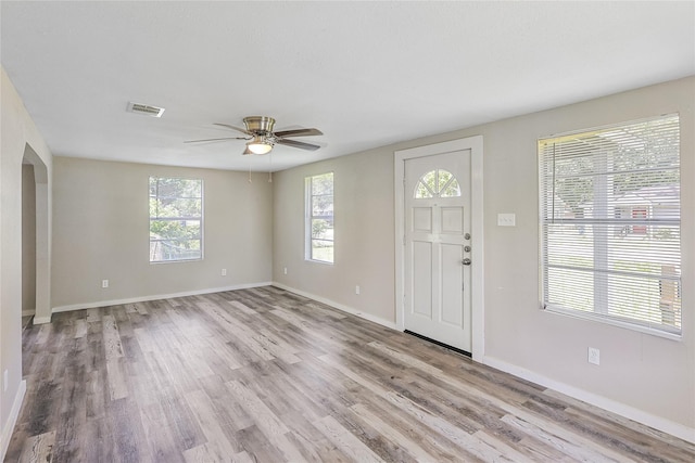 1011 N Arcola St, Angleton, TX 77515 - foyer with healthy amount of natural light, a ceiling fan, wood finished floors, and arched walkways