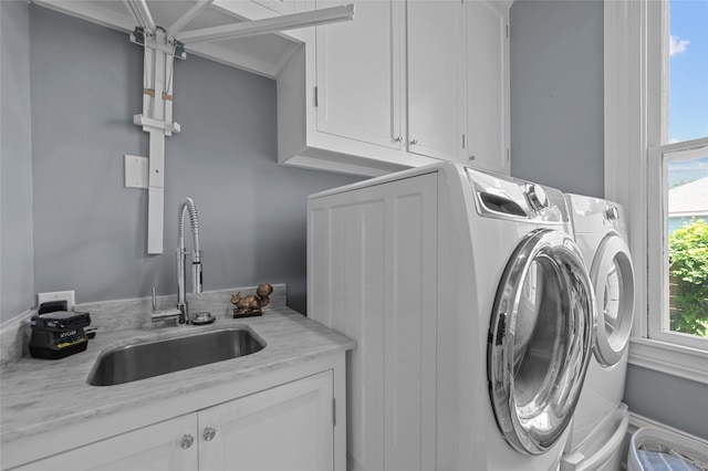 1818 Decatur St, Houston, TX 77007 - laundry area with cabinet space and washing machine and clothes dryer