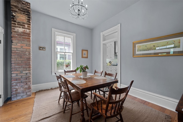 1818 Decatur St, Houston, TX 77007 - dining area featuring a chandelier, light wood-type flooring, and baseboards