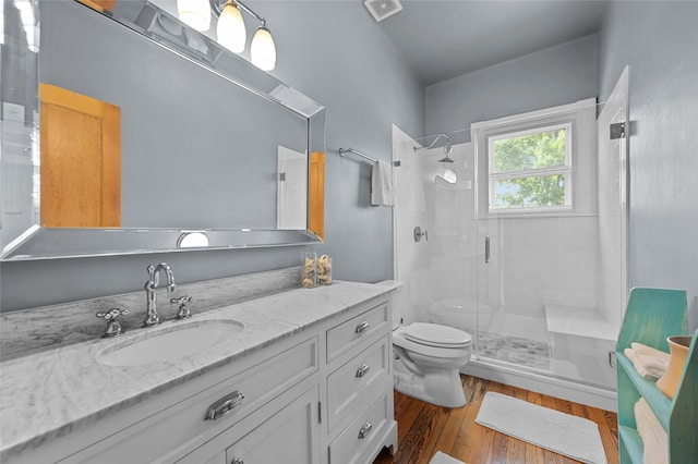 1818 Decatur St, Houston, TX 77007 - full bathroom with toilet, vanity, a stall shower, and wood finished floors