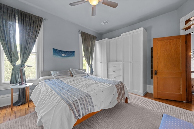 1818 Decatur St, Houston, TX 77007 - bedroom with multiple windows, light wood finished floors, ceiling fan, and baseboards