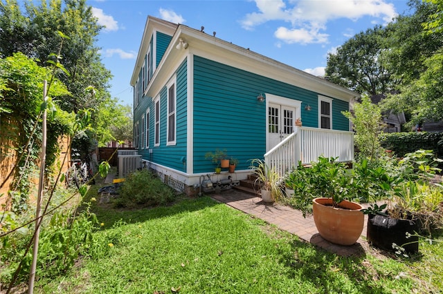 1818 Decatur St, Houston, TX 77007 - back of property featuring a lawn and central AC