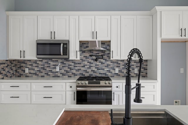 250 Hampton Glen Rd, Montgomery, TX 77356 - kitchen featuring appliances with stainless steel finishes, light countertops, and white cabinetry