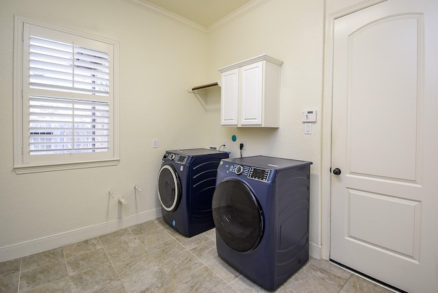 laundry room featuring ornamental molding, separate washer and dryer, cabinet space, and baseboards