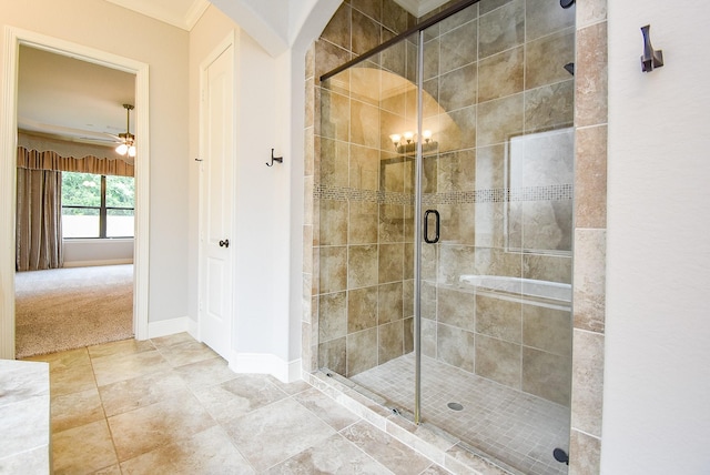 full bathroom with a shower stall, ceiling fan, and baseboards