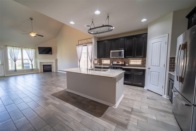 5422 Nobel Earl Ct, Katy, TX 77493 - kitchen featuring appliances with stainless steel finishes, a sink, ceiling fan, healthy amount of natural light, and lofted ceiling